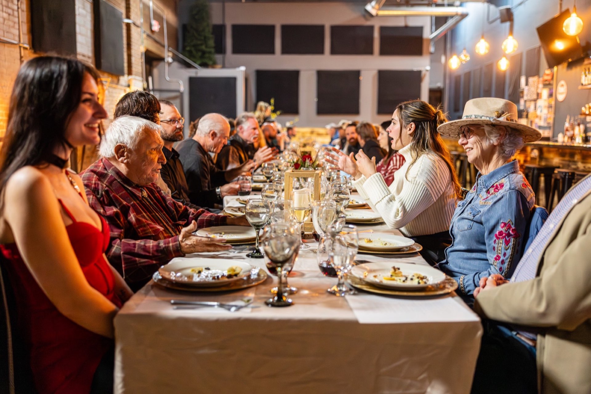 Wyoming community gathering around a long table prepared for dinner