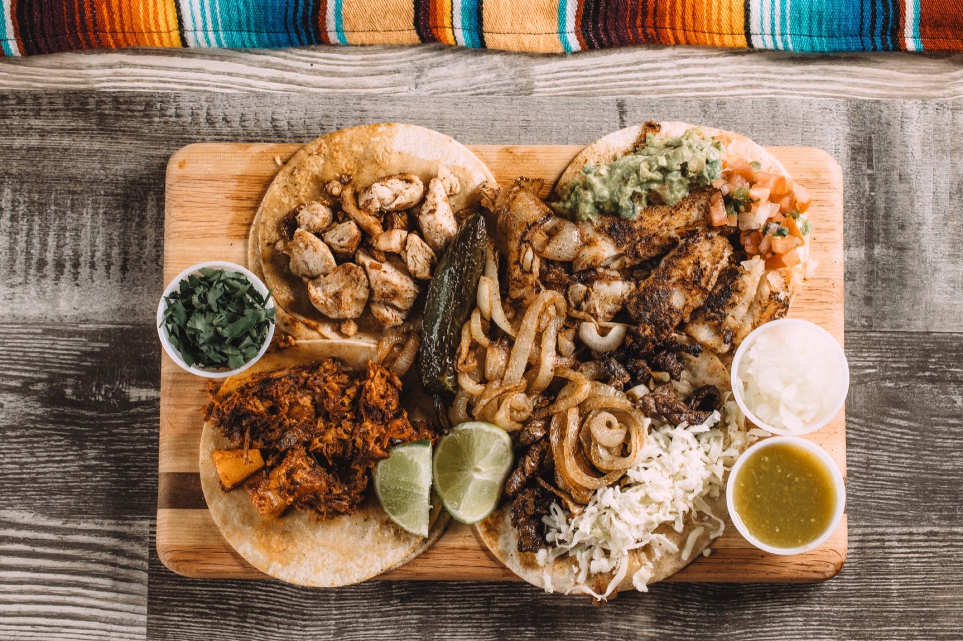 Prepared tacos on a wooden board, representing Wyoming food craft and place-based storytelling